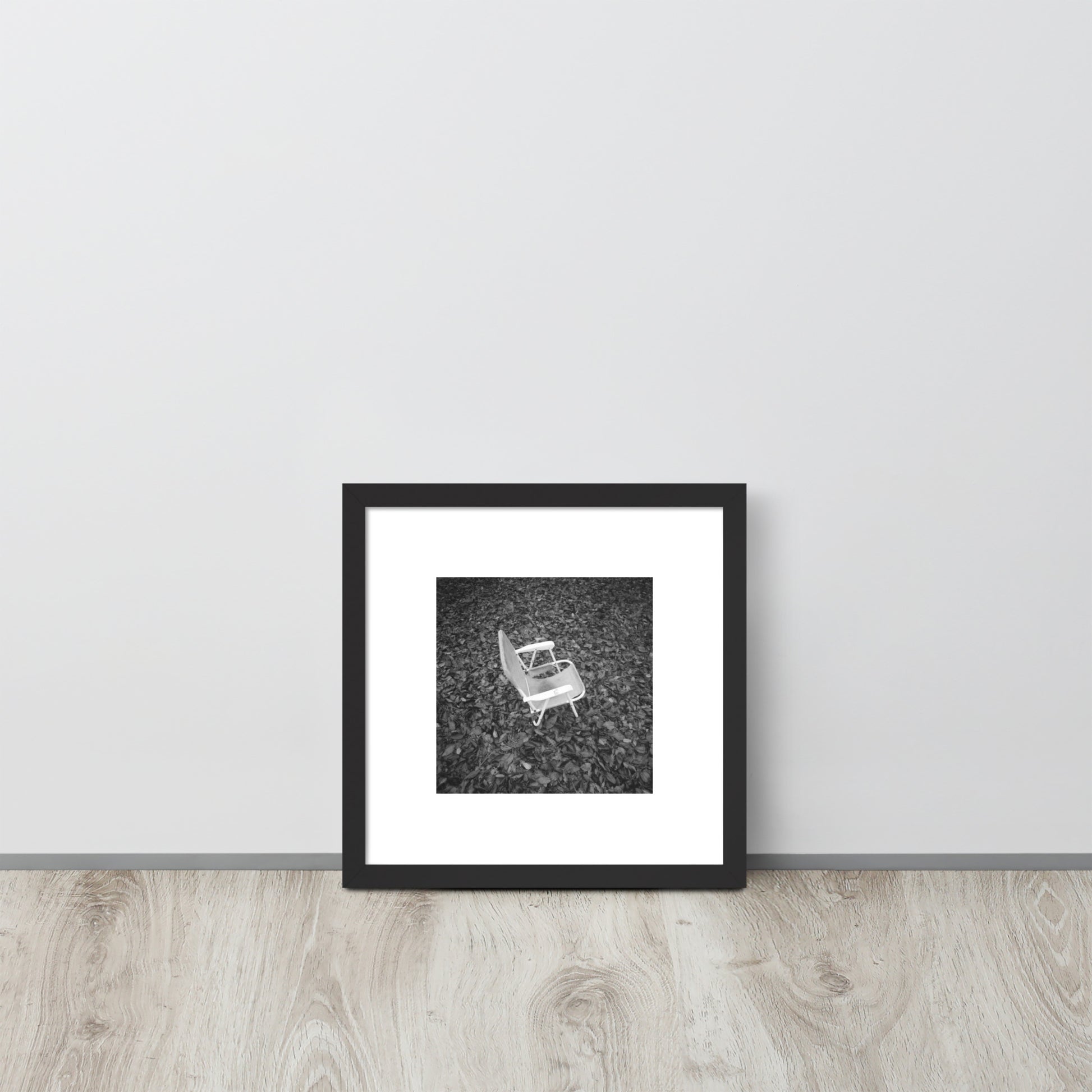 Fallen Leaves and Chair (B&W) Art – Framed Matte Paper Poster, Black Frame, Lifestyle View