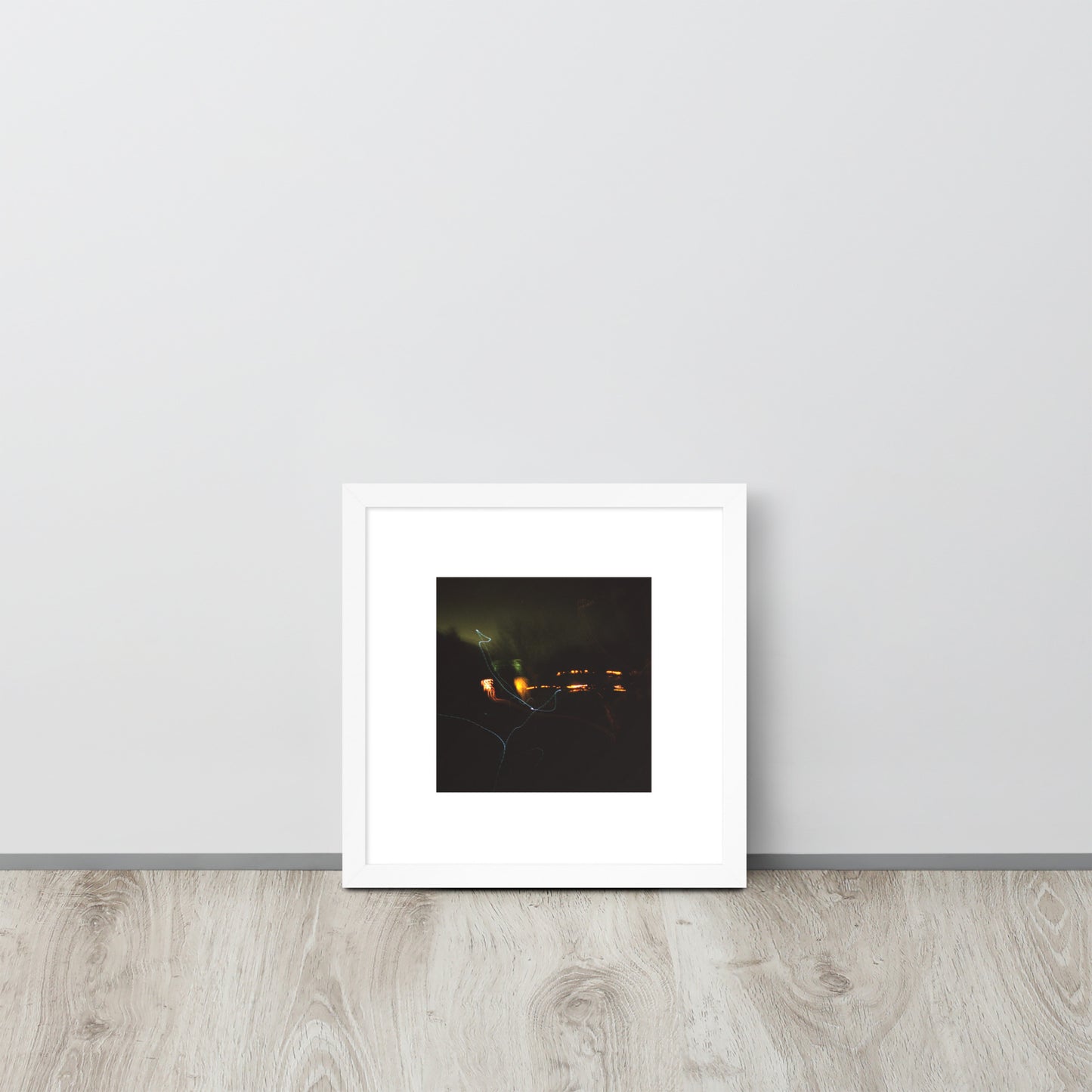 Minimalist streetwear style framed wall art in matte white, featuring a 'Night Light' photograph. / Night Light 額装ポスター（ホワイトフレーム）：クリーンな白枠がモダンな空間を演出する、夜の光の風景を捉えたモードストリート系インテリアアート。