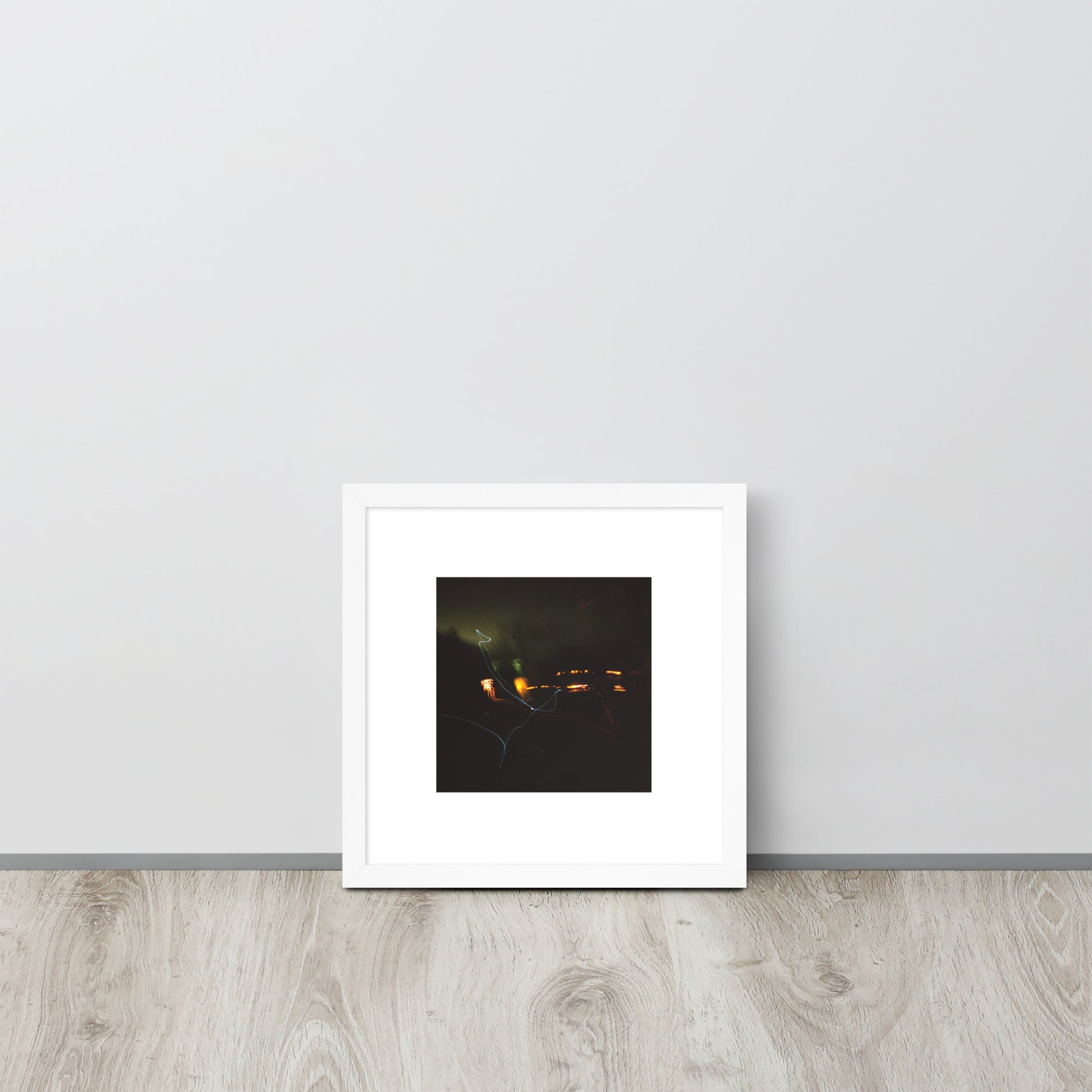 Minimalist streetwear style framed wall art in matte white, featuring a 'Night Light' photograph. / Night Light 額装ポスター（ホワイトフレーム）：クリーンな白枠がモダンな空間を演出する、夜の光の風景を捉えたモードストリート系インテリアアート。