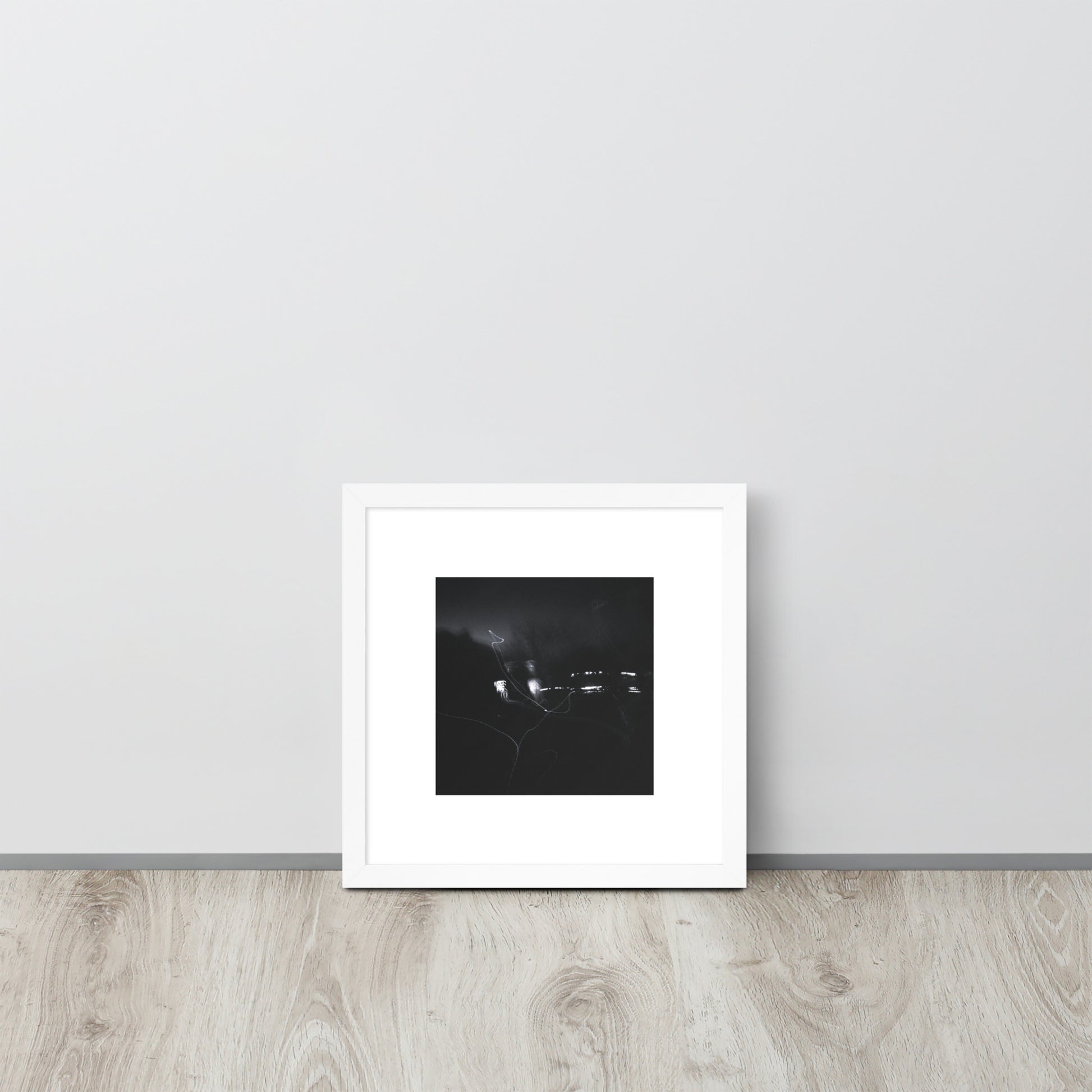 Minimalist streetwear style framed wall art in matte white, featuring a 'Night Light (B&W)' photograph. / Night Light (B&W) 額装ポスター（ホワイトフレーム）：クリーンな白枠がモダンな空間を演出する、夜の光のモノクロ風景を捉えたモードストリート系インテリアアート。