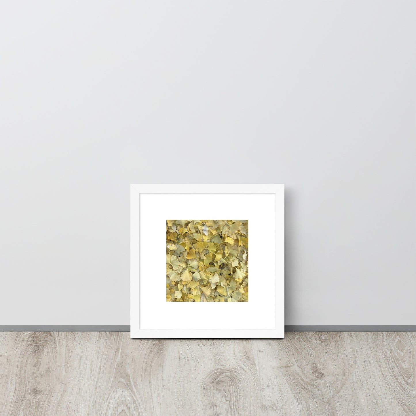 Minimalist art framed matte paper poster in white frame featuring the 'Ginkgo Fallen Leaves' photo art. / フレーム付きマットペーパーポスター（ホワイトフレーム）：「イチョウの落ち葉」のフォトアートを配したミニマリストデザイン。