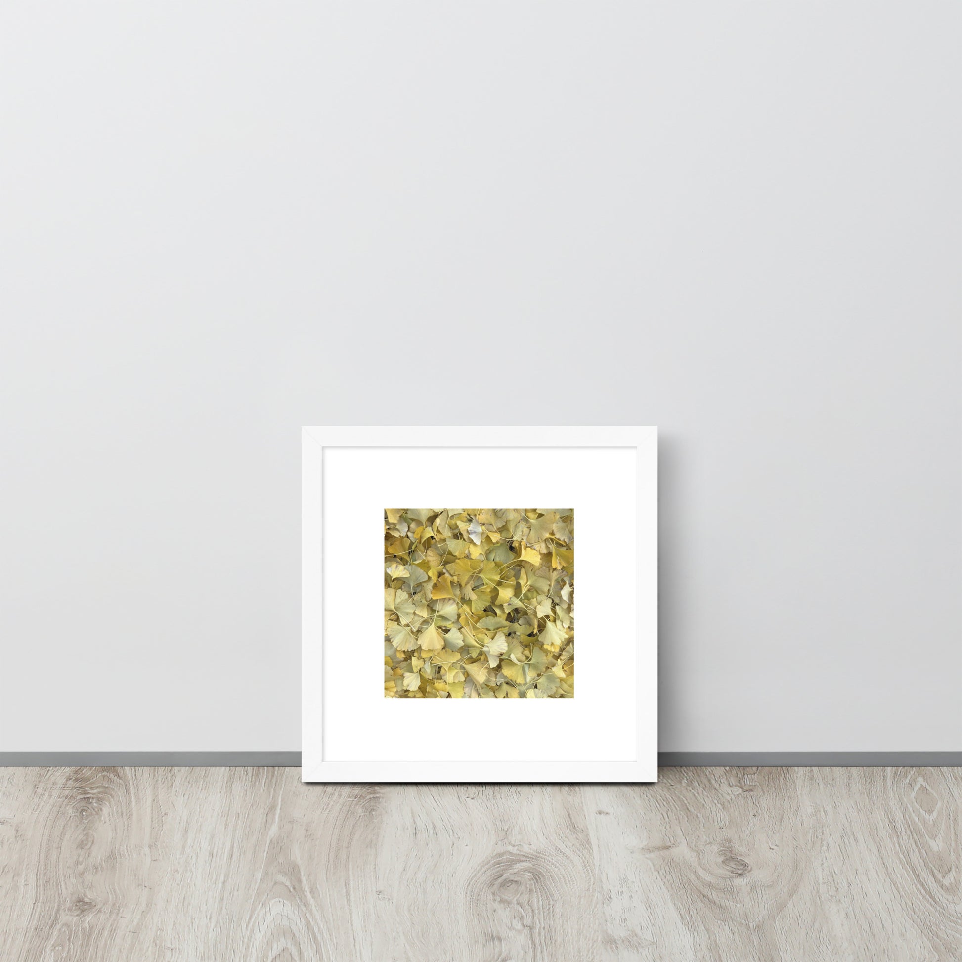 Minimalist art framed matte paper poster in white frame featuring the 'Ginkgo Fallen Leaves' photo art. / フレーム付きマットペーパーポスター（ホワイトフレーム）：「イチョウの落ち葉」のフォトアートを配したミニマリストデザイン。
