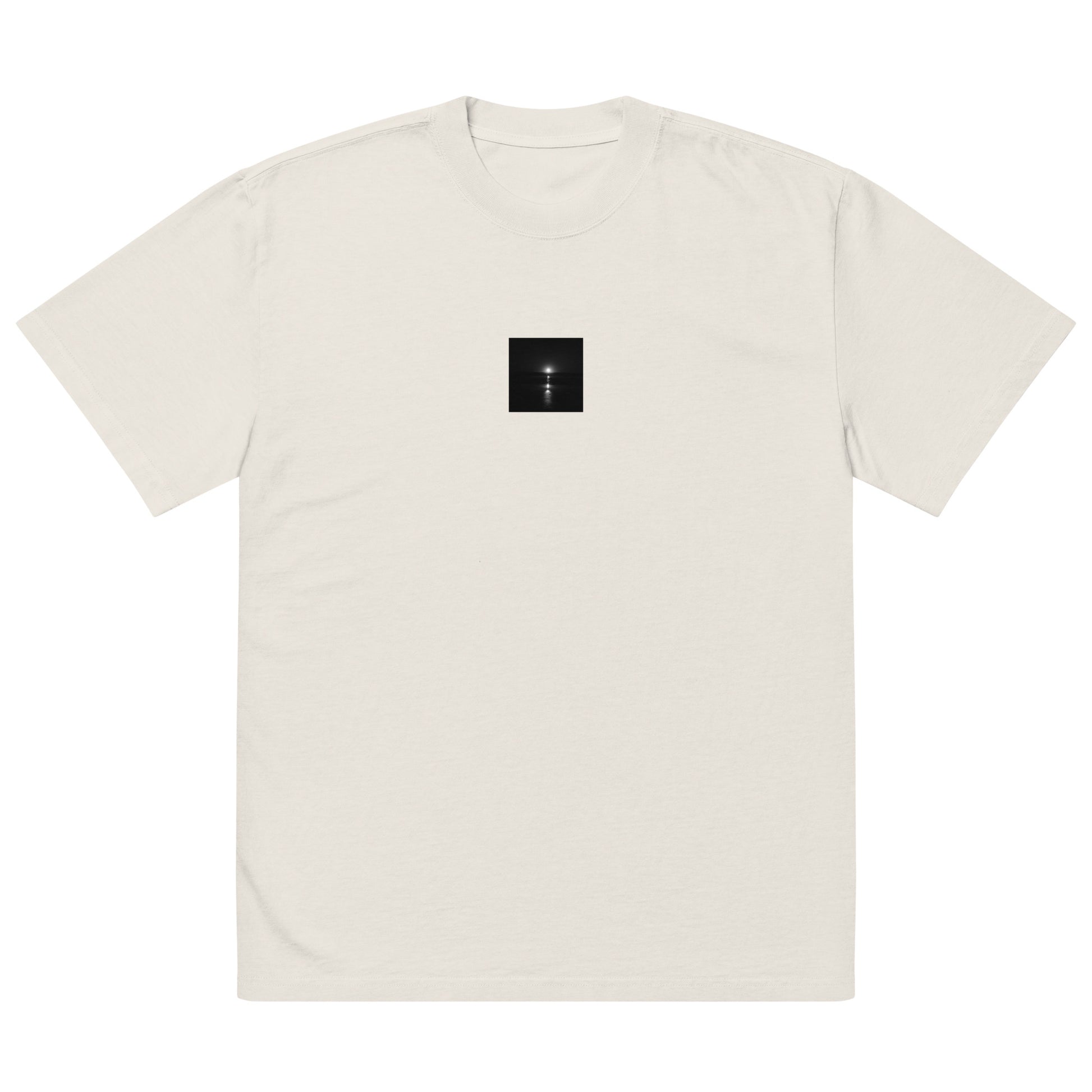 Minimalist streetwear style oversized faded T-shirt in faded bone, featuring the 'Ocean Sunbeams (B&W)' photograph. / 「Ocean Sunbeams (B&W)」オーバーサイズTシャツ（フェードボーン）：柔らかなオフホワイトにモノクロのコントラストが際立つ、清潔感のあるモードストリートTシャツ。