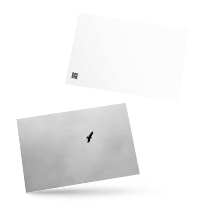 Lifestyle shot of a person holding the 'Bird and Sky (B&W)' postcard, highlighting its thick, high-quality matte paper texture. / 「Bird and Sky (B&W)」ポストカード：手に馴染む厚手のマット紙を使用したポストカード。大切な人へのメッセージカードとしてはもちろん、ミニ・アートとしても楽しめます。