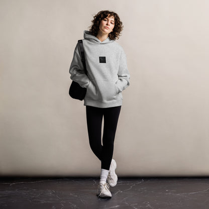 Minimalist streetwear style unisex oversized hoodie in athletic heather, featuring a 'Night Light (B&W)' photograph print on the chest. / Night Light (B&W) オーバーサイズ・フーディー（アスレチックヘザー）：都会的な杢グレーに夜の光のモノクロ風景が馴染む、モードストリートのためのモダンなパーカー。
